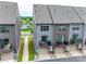 Exterior townhome shot showing individual garages and balconies, and neutral gray siding at 556 Billingsley Rd, Charlotte, NC 28211