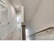 Upstairs hallway featuring a carpeted floor and white doors at 556 Billingsley Rd, Charlotte, NC 28211