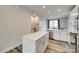 Bright kitchen featuring white cabinets, stainless steel appliances and an island at 556 Billingsley Rd, Charlotte, NC 28211