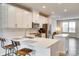 Modern kitchen features white cabinets, stainless steel appliances, and bar stool seating at 556 Billingsley Rd, Charlotte, NC 28211