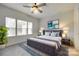 Bright bedroom with large windows, neutral colors, ceiling fan and stylish furnishings at 556 Billingsley Rd, Charlotte, NC 28211