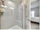 Modern tiled shower showcases glass doors, a built-in seat, and sleek fixtures, enhancing its spa-like feel at 556 Billingsley Rd, Charlotte, NC 28211