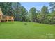 Expansive backyard with a wooden deck and fire pit, perfect for outdoor activities and relaxation at 5564 N Hillsdale Dr, Fort Lawn, SC 29714