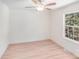 Bright bedroom features neutral walls, light wood floors, and a window showcasing greenery at 5564 N Hillsdale Dr, Fort Lawn, SC 29714