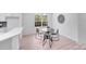 Bright dining area with a black table, modern chairs, and view into the kitchen at 5564 N Hillsdale Dr, Fort Lawn, SC 29714