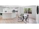 Dining area with table, chairs, and view into the modern kitchen at 5564 N Hillsdale Dr, Fort Lawn, SC 29714