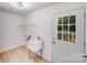 Modern laundry room featuring a utility sink, shelving, and access to the outdoors with a windowed door at 5564 N Hillsdale Dr, Fort Lawn, SC 29714