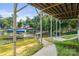 Lush backyard with a hammock and a walkway leading to the waterfront at 592 Shoreline Rd, New London, NC 28127