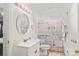 Bright bathroom featuring a white vanity and charming lake-themed shower curtain at 592 Shoreline Rd, New London, NC 28127