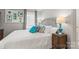 Well-lit bedroom featuring a comfortable bed with a decorative lamp on the nightstand at 592 Shoreline Rd, New London, NC 28127