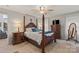 Spacious primary bedroom with a king bed and full wooden dresser at 592 Shoreline Rd, New London, NC 28127