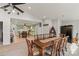 Open dining room adjacent to the kitchen with beautiful decor and a guitar next to an antique-looking armoire at 592 Shoreline Rd, New London, NC 28127