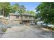 Exterior view of a lakefront house with a large driveway, deck and easy water access at 592 Shoreline Rd, New London, NC 28127