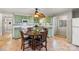 Charming kitchen with green cabinets, stainless appliances, and a round wooden table set with black chairs at 592 Shoreline Rd, New London, NC 28127