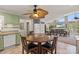Charming kitchen with green cabinets, stainless appliances, and a round wooden table set with black chairs at 592 Shoreline Rd, New London, NC 28127