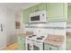 Updated kitchen featuring green cabinetry, granite countertops, subway tile backsplash and stainless steel appliances at 592 Shoreline Rd, New London, NC 28127