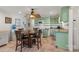 Charming kitchen with green cabinets, stainless appliances, and a round wooden table set with black chairs at 592 Shoreline Rd, New London, NC 28127