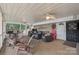 Inviting screened-in porch with comfortable seating and ceiling fans, perfect for relaxing outdoors at 592 Shoreline Rd, New London, NC 28127