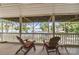 Enclosed porch with chairs and views of the lake at 592 Shoreline Rd, New London, NC 28127