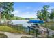 Lakeside property showcasing a covered boat dock and serene water views at 592 Shoreline Rd, New London, NC 28127