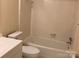 Bathroom features a tub and shower combo with white fixtures and tiling throughout at 623 S New Hope Rd # 9, Gastonia, NC 28054