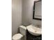 Bathroom features white fixtures, cabinet and toilet with a dark vanity cabinet and large mirror at 623 S New Hope Rd # 9, Gastonia, NC 28054