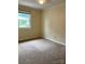 Comfortable bedroom featuring plush carpeting and a window offering natural light at 623 S New Hope Rd # 9, Gastonia, NC 28054