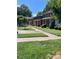 Brick townhouses with covered porches, walkways, lush lawns and various decorative bushes at 623 S New Hope Rd # 9, Gastonia, NC 28054