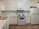 Bright kitchen with white cabinets, appliances, plenty of counter space, and neutral flooring at 623 S New Hope Rd # 9, Gastonia, NC 28054