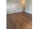 Spacious room with light gray walls, white trim and gorgeous wood grain laminate flooring throughout at 623 S New Hope Rd # 9, Gastonia, NC 28054