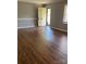 Room features an exterior door, light gray walls, white trim and gorgeous wood grain laminate flooring at 623 S New Hope Rd # 9, Gastonia, NC 28054