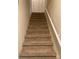 Carpeted staircase with white railing leading to an upper level with closet space at 623 S New Hope Rd # 9, Gastonia, NC 28054