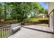 Backyard area with a wooden deck, bench, and lush greenery, offering a relaxing outdoor space at 6713 William Harry Ct, Charlotte, NC 28211