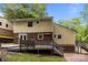 Exterior view showcasing a spacious wooden deck, brick accents, and verdant backyard of the house at 6713 William Harry Ct, Charlotte, NC 28211