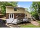 Exterior angle of the property with a cozy deck area and brick detailing, all surrounded by a well-maintained lawn at 6713 William Harry Ct, Charlotte, NC 28211