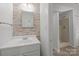 Neutral bathroom with vanity, square mirror and shower entry at 6713 William Harry Ct, Charlotte, NC 28211