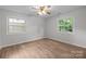 Charming bedroom with hardwood floors, two windows, ceiling fan with light at 6713 William Harry Ct, Charlotte, NC 28211