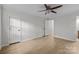 Spacious bedroom with neutral walls, ceiling fan and light wood flooring at 6713 William Harry Ct, Charlotte, NC 28211