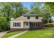 Charming two-story home features a brick foundation, inviting entrance, and lush, mature landscaping at 6713 William Harry Ct, Charlotte, NC 28211