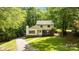 Charming two-story home features a brick foundation, inviting entrance, and lush, mature landscaping at 6713 William Harry Ct, Charlotte, NC 28211