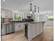 Modern kitchen with an island, stainless steel appliances, and a wine cooler at 6713 William Harry Ct, Charlotte, NC 28211