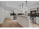 Modern kitchen with an island, stainless steel appliances, and hardwood floors at 6713 William Harry Ct, Charlotte, NC 28211