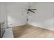 Spacious living room with white walls, a fireplace, and wood flooring at 6713 William Harry Ct, Charlotte, NC 28211