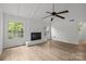 Bright living room features a painted brick fireplace and wood flooring at 6713 William Harry Ct, Charlotte, NC 28211