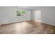 Light-filled living room with wood flooring and bright windows at 6713 William Harry Ct, Charlotte, NC 28211