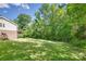 Large backyard surrounded by mature trees, offering privacy and a natural setting at 679 Fairforest Rd, Chester, SC 29706