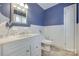 Charming bathroom with white vanity, classic fixtures, and blue walls, creating a serene atmosphere at 679 Fairforest Rd, Chester, SC 29706