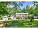 Charming two-story home with a well-maintained lawn and mature trees providing ample shade and privacy at 679 Fairforest Rd, Chester, SC 29706