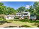 Charming two-story home with a well-manicured lawn, detached garage, and inviting curb appeal at 679 Fairforest Rd, Chester, SC 29706