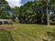 Sprawling back yard with trees, lawn, and a garden shed at 6922 Woodstock Dr, Charlotte, NC 28210